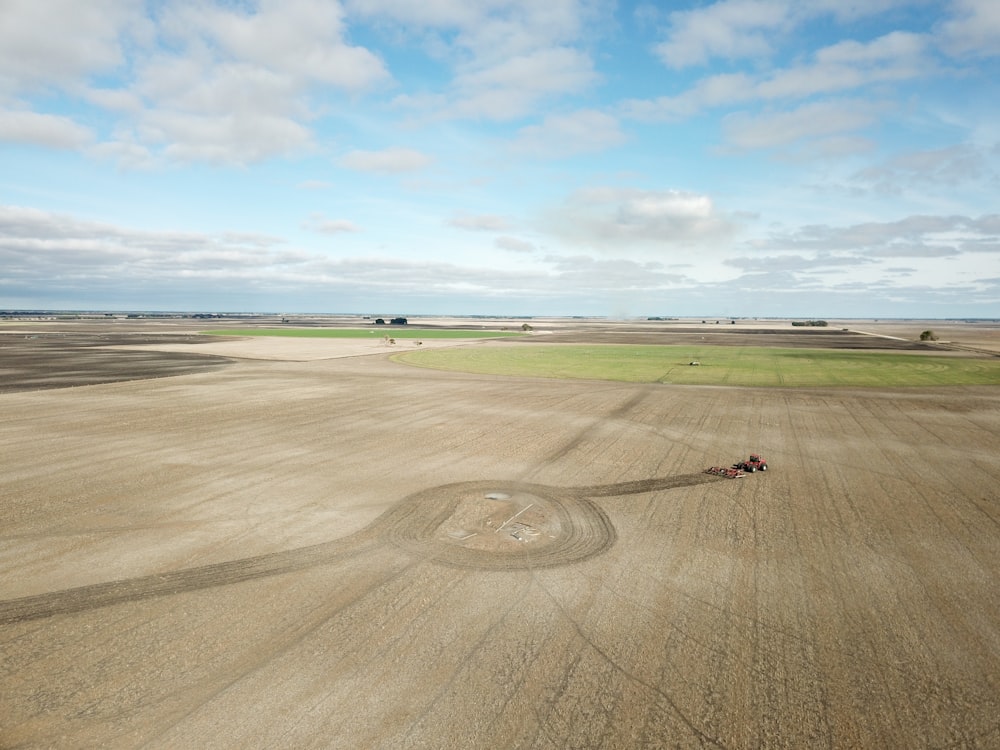 a tractor is driving through a large field