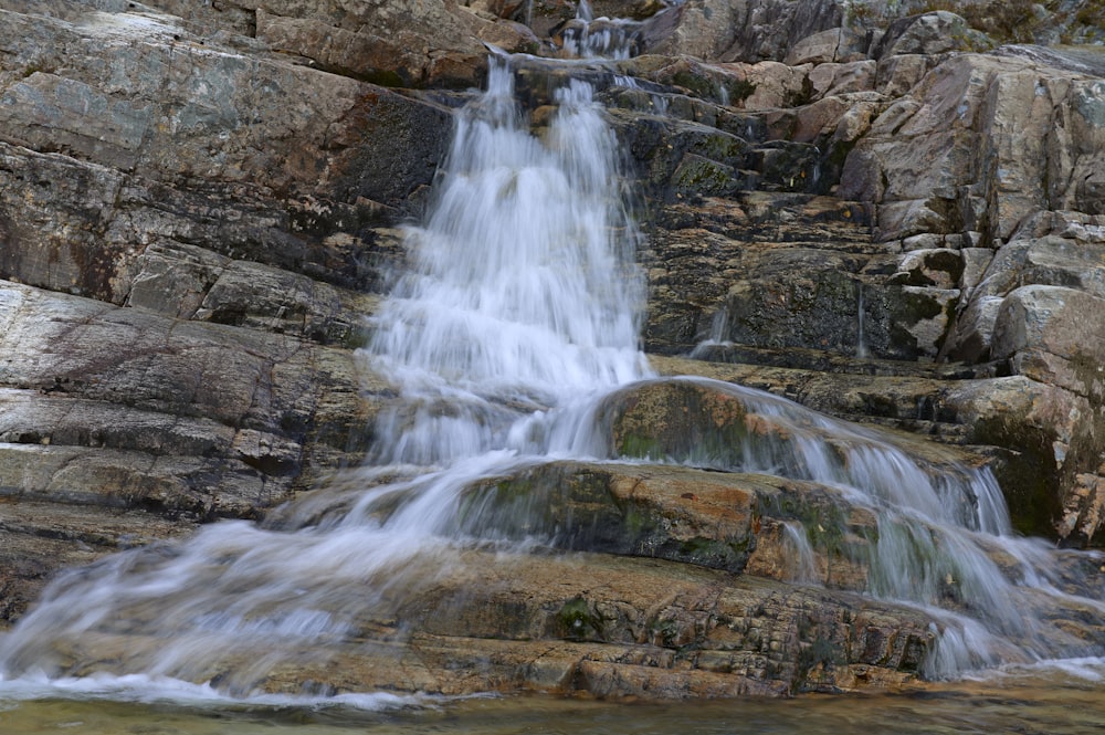 waterfalls on brown rock