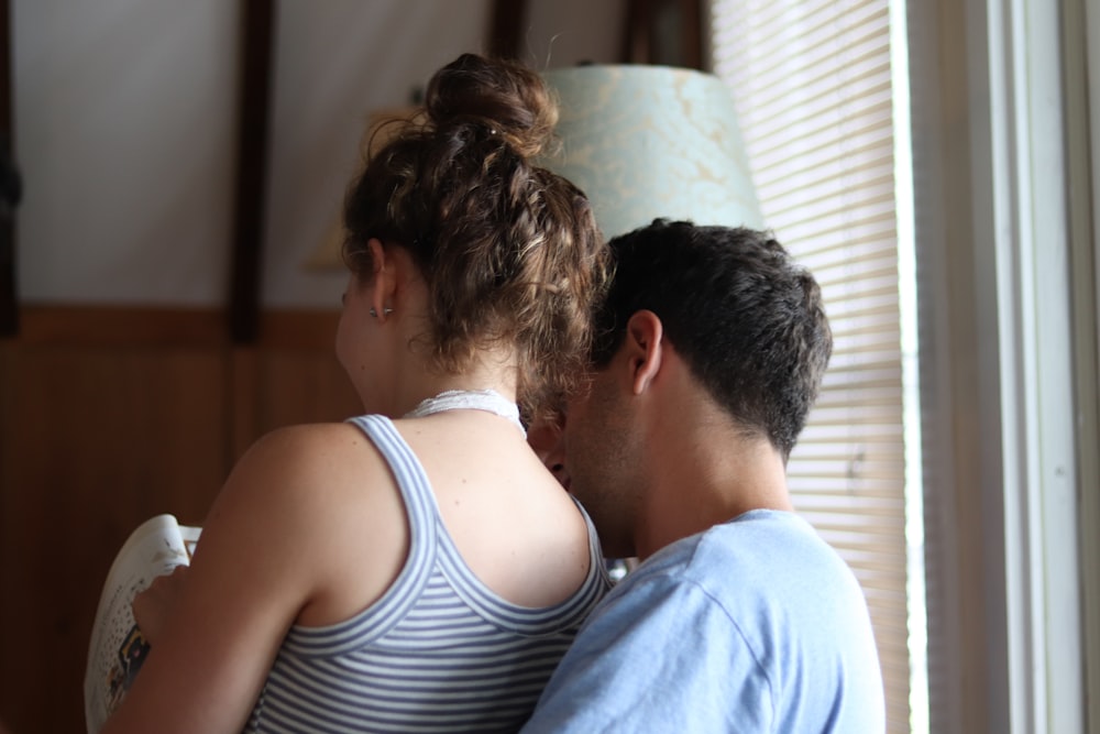 woman sitting on man's lap