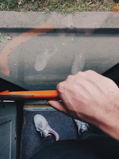 A driver helping a passenger with mobility aids step out of the vehicle with care.