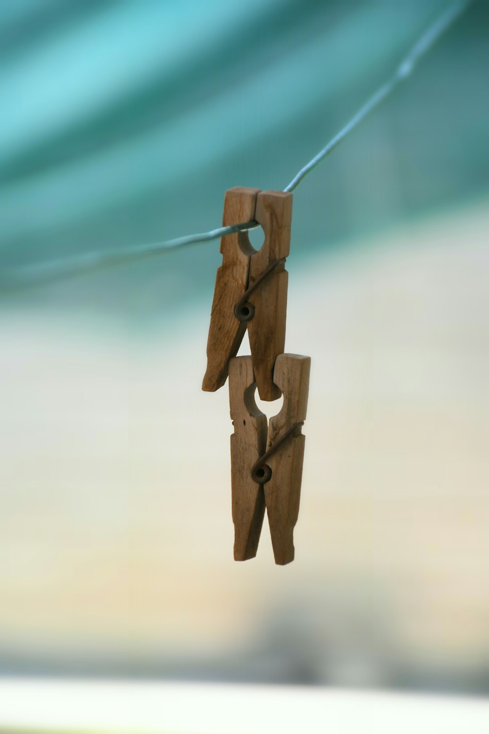 two brown wooden clothes pin on clothes line