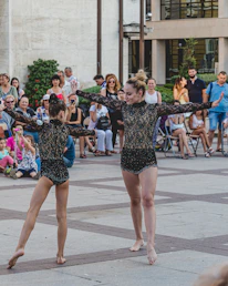 Dancers performing a vibrant hip-hop routine during an outdoor showcase in Amsterdam.