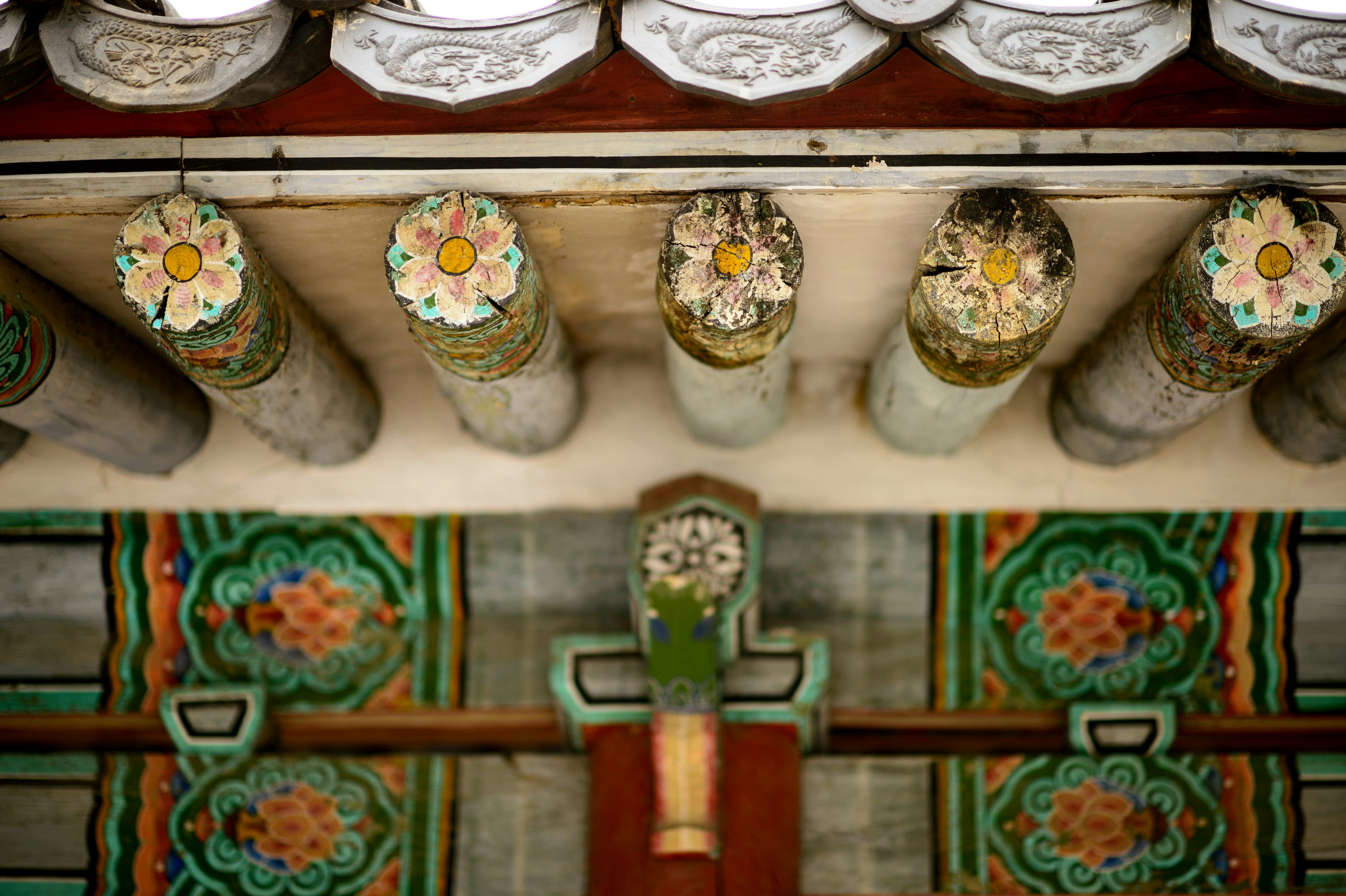 a close up of a cross with flowers on it