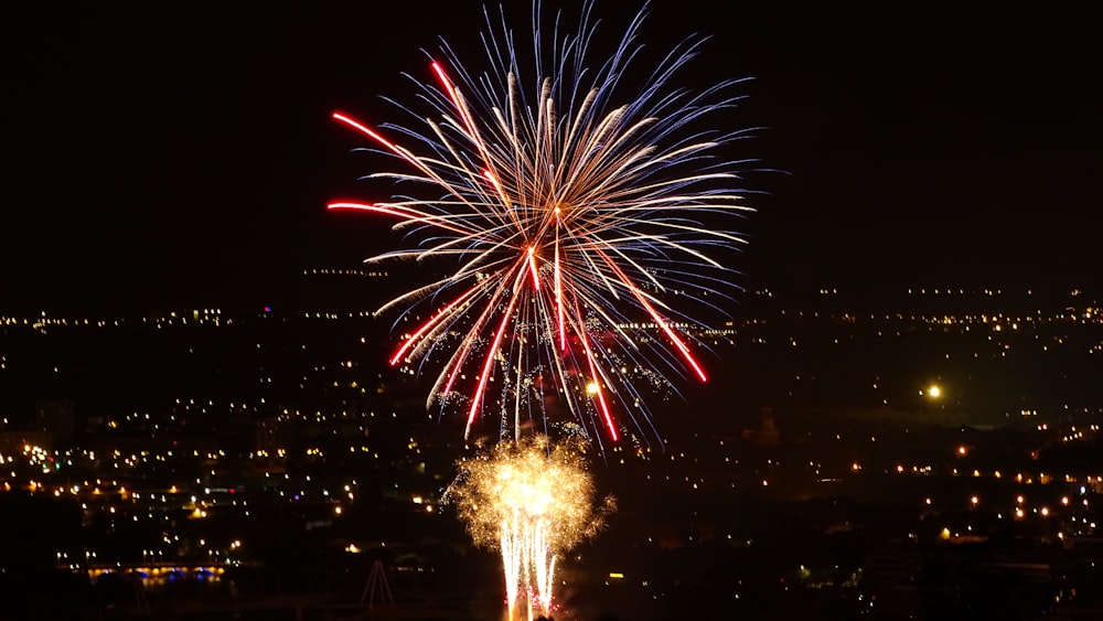 white, red, and blue fireworks close-up photography