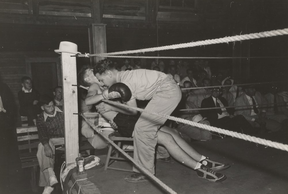grayscale photo of boxer sits and facing man