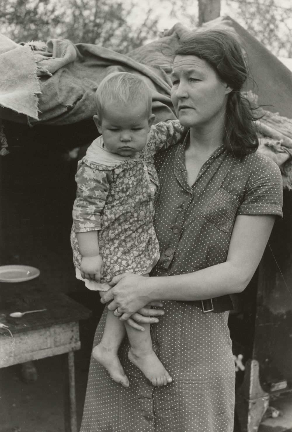 grayscale photo of woman carrying child