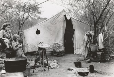 two women standing near tent tent teams background