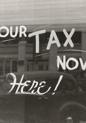 a sign that says pay your tax now here