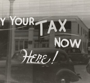 a sign that says pay your tax now here