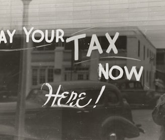 a sign that says pay your tax now here