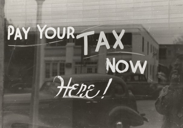 a sign that says pay your tax now here