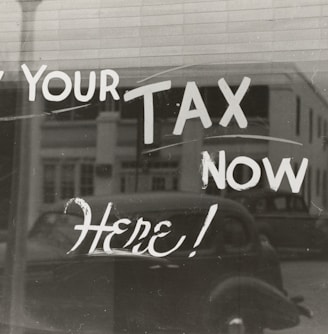 a sign that says pay your tax now here