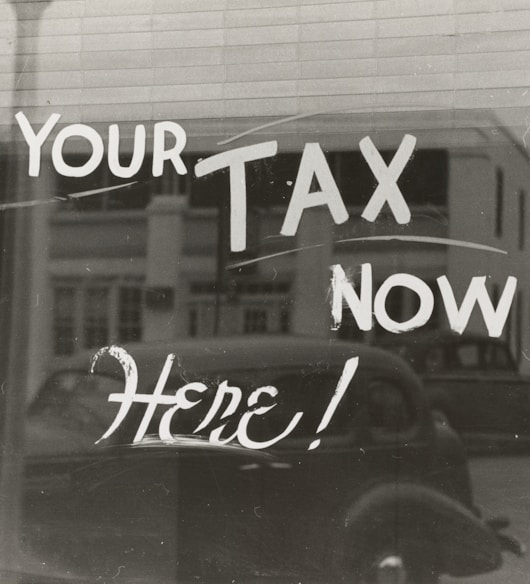 a sign that says pay your tax now here