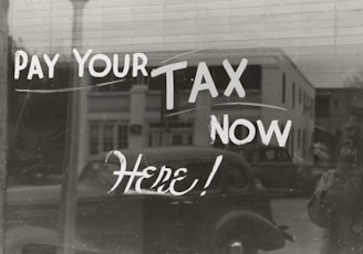 a sign that says pay your tax now here