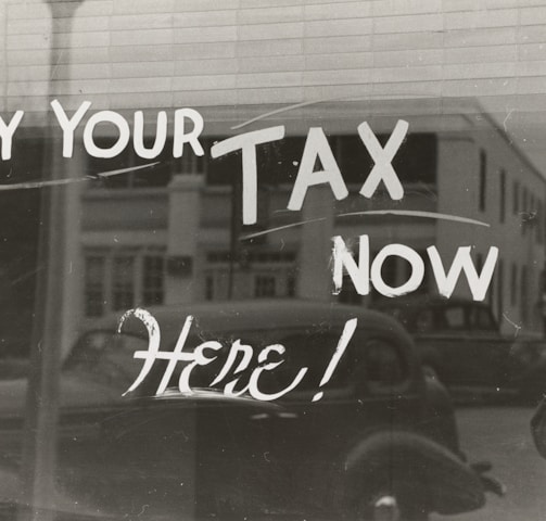 a sign that says pay your tax now here