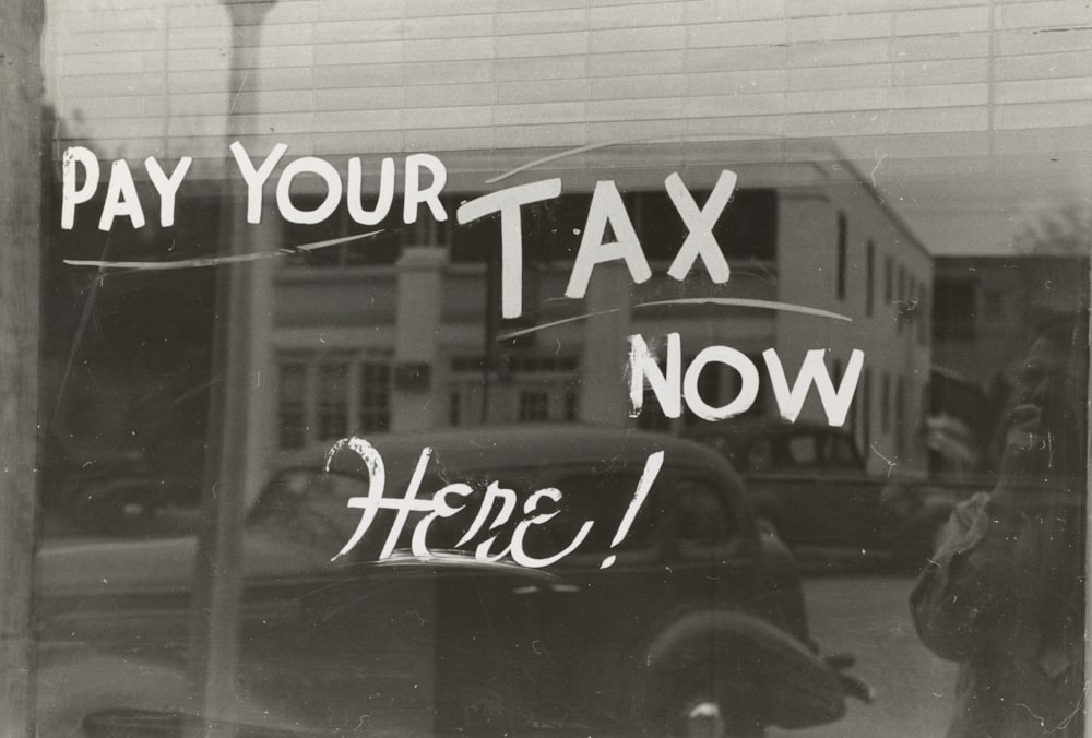 a sign that says pay your tax now here