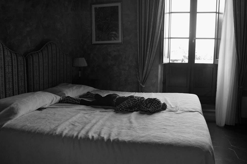 girl wearing Spider-man costume lying on bed