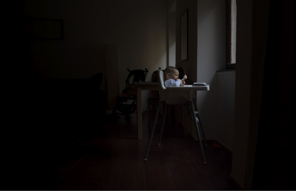 baby sitting on highchair