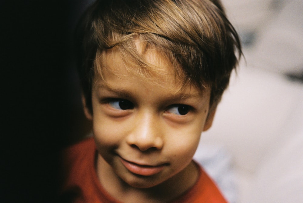 smiling boy in red shirt