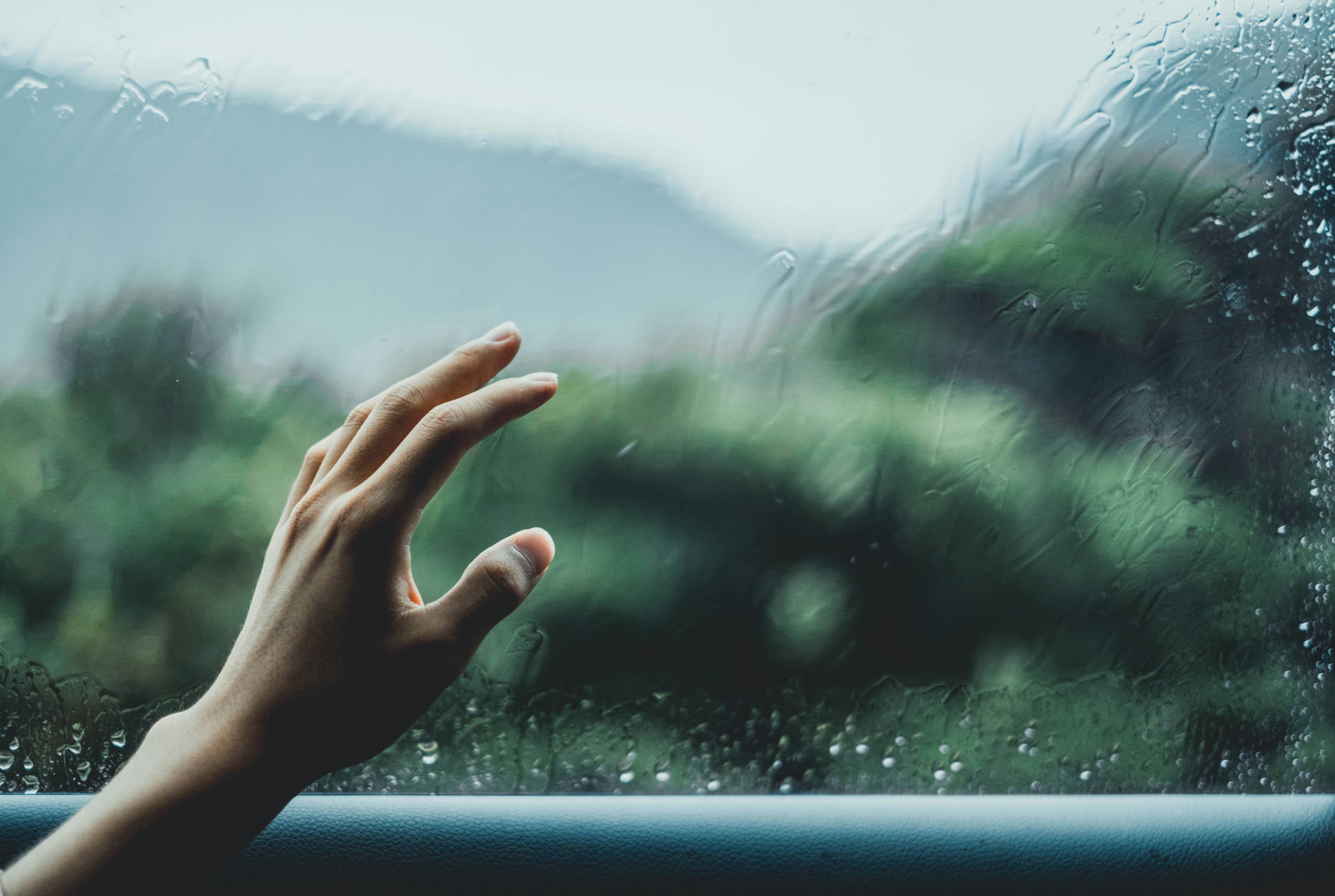 person about to touch glass