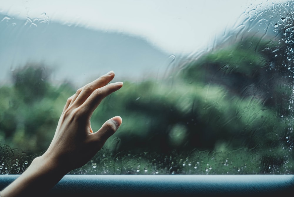 person about to touch glass