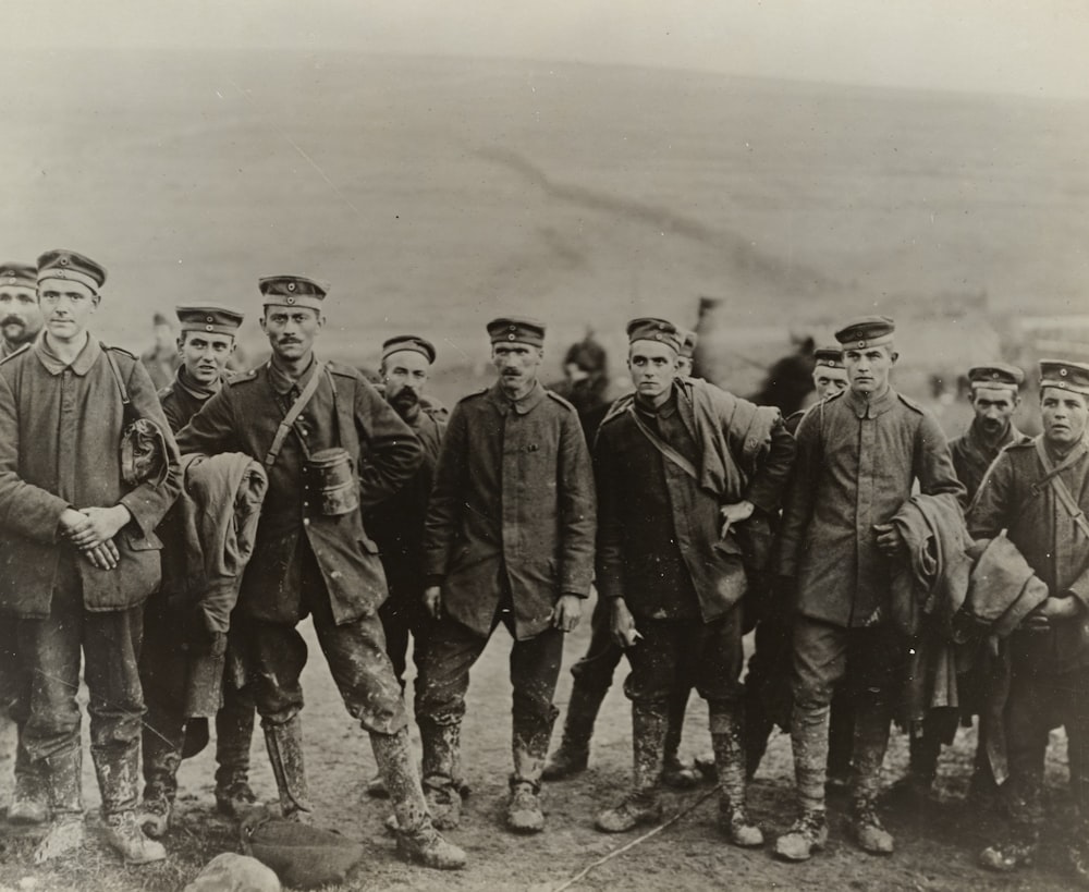 grayscale photography of group of men wearing soldier suit