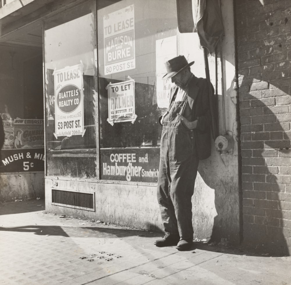 man standing beside wall