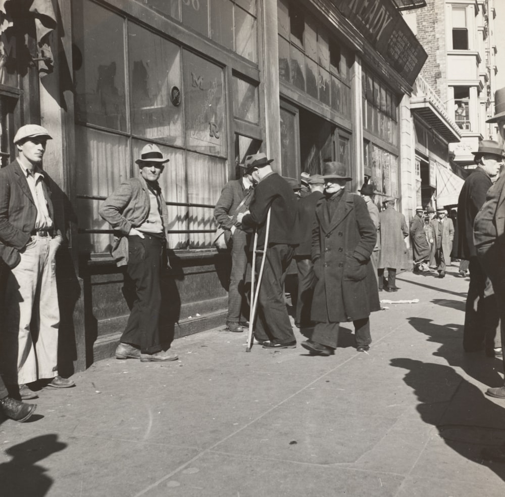 people near buildings in grayscale