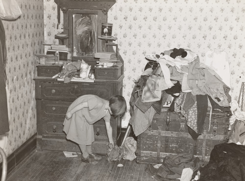 Girl Beside Vanity Dresser And Clothes Photo Free Grey Image On
