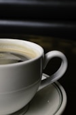 Close-up of hands holding a coffee cup, highlighting the care in every detail