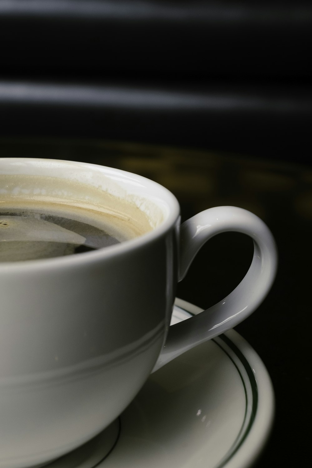 white ceramic teacup with saucer