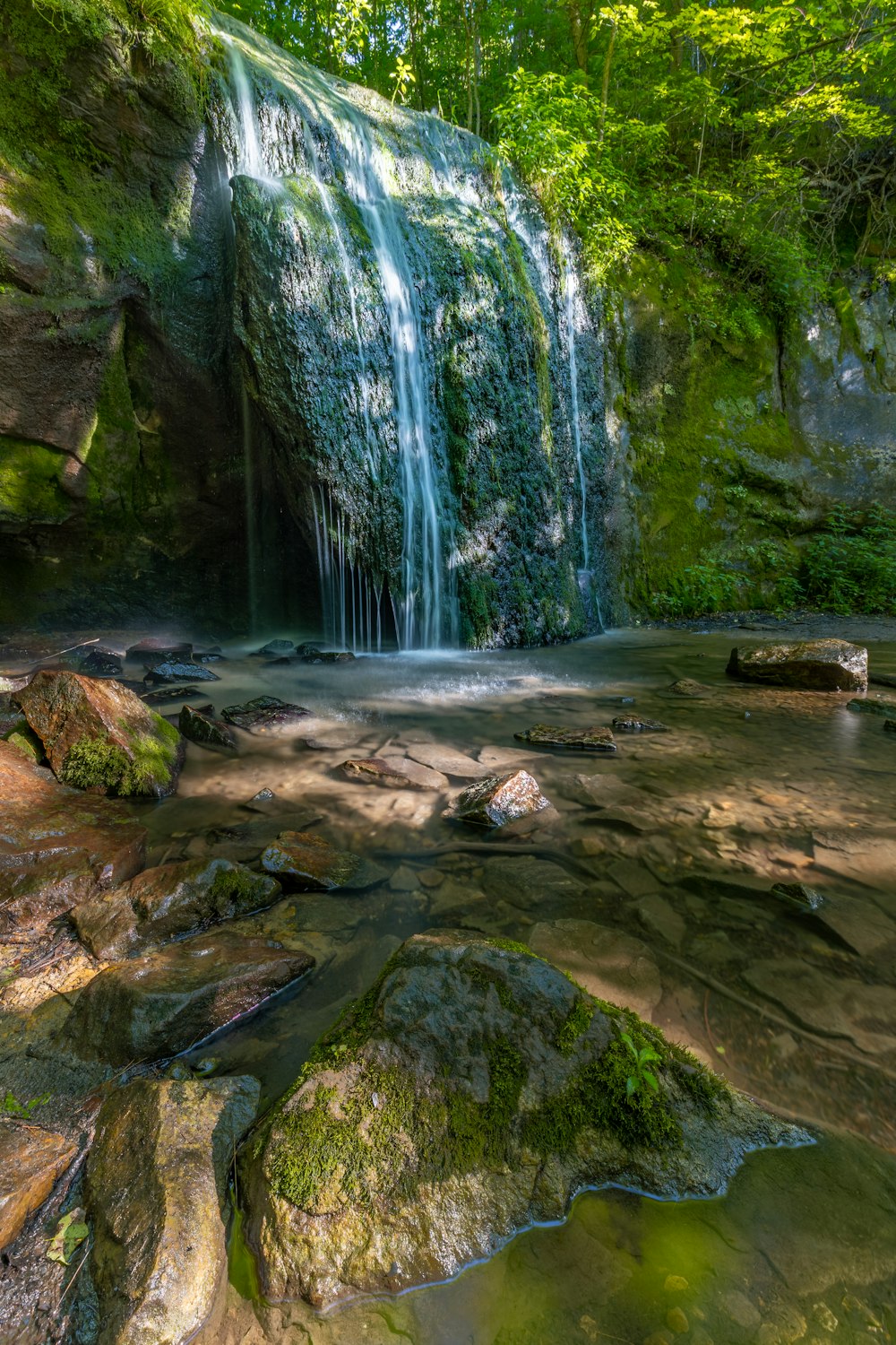 selective photography of waterfalls at daytime