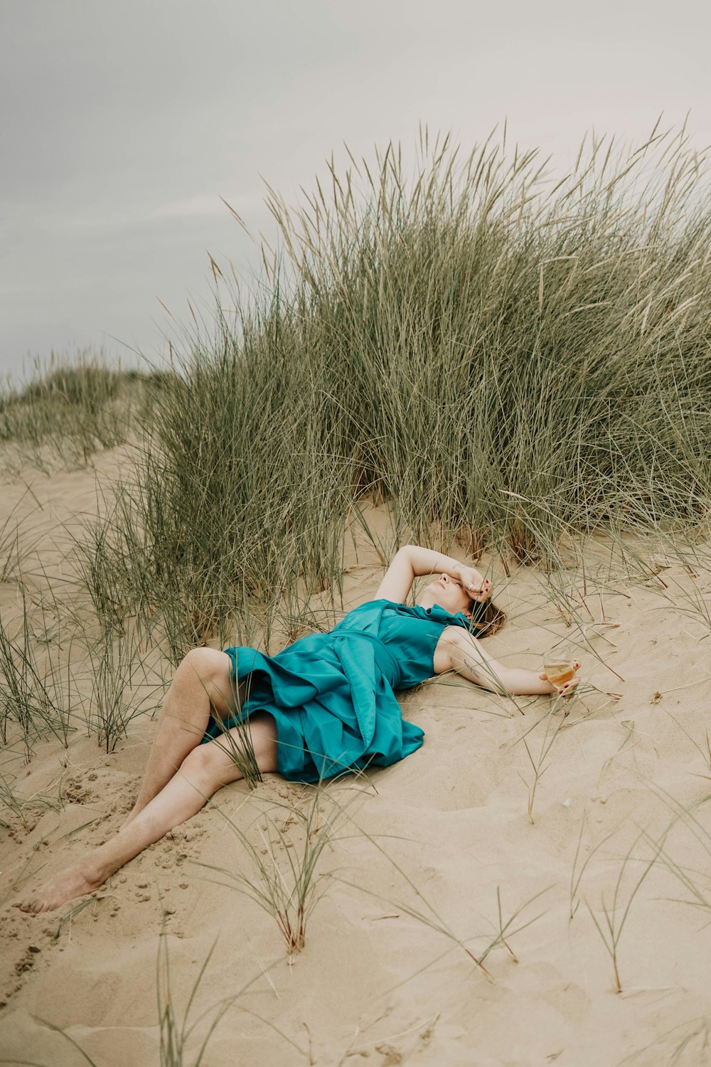 woman laying down on sand