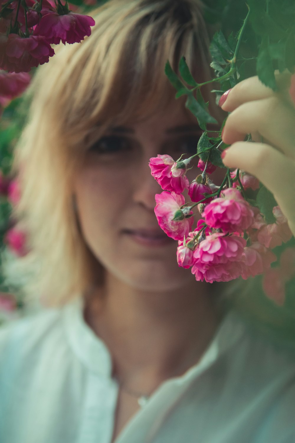 woman holding flower during daytime