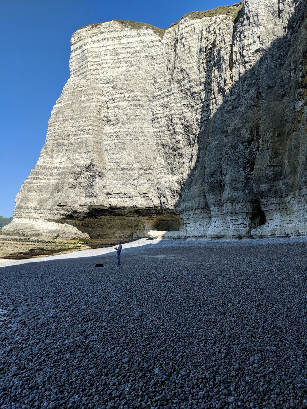 person standing near rocky hill during daytime