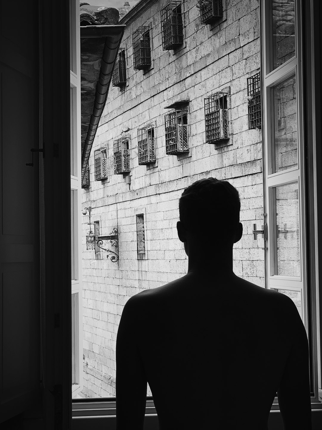 silhouette photography unknown person near window
