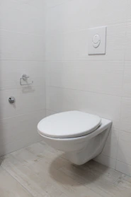 Modern white ceramic toilets installed in a stylish bathroom setting