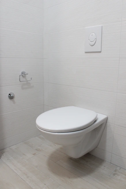 SUKHA SENSE installed on a minimalist white toilet with soft beige and charcoal accents
