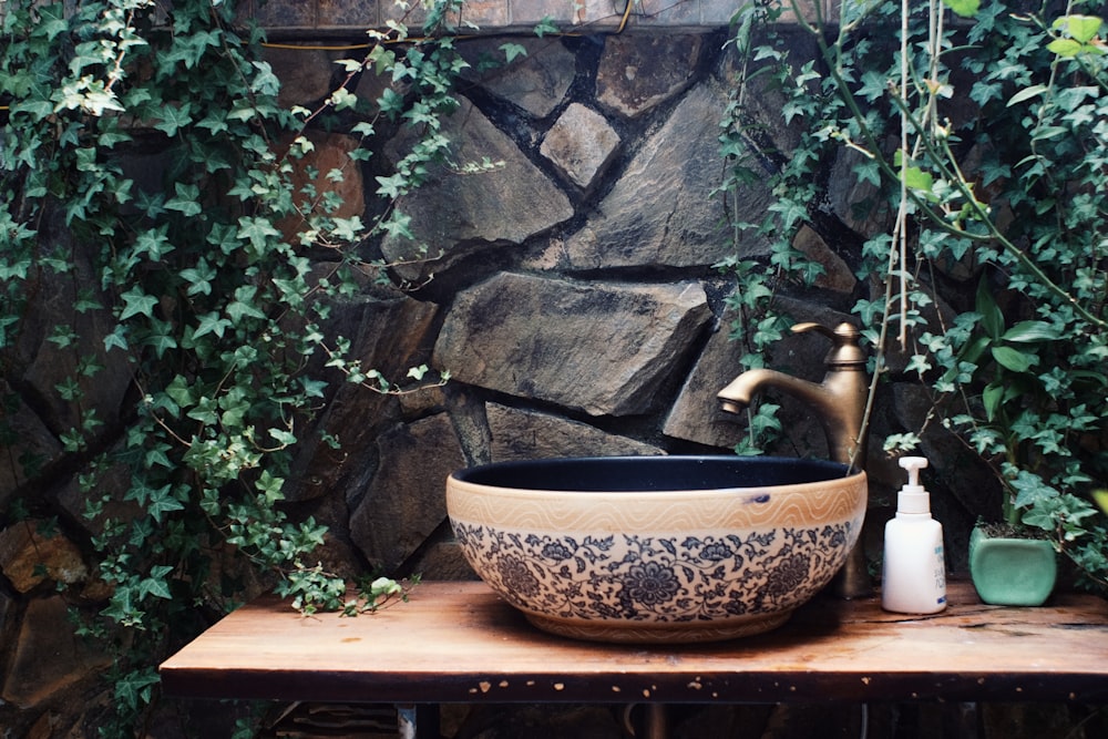 brass-colored and black floral sink with faucet