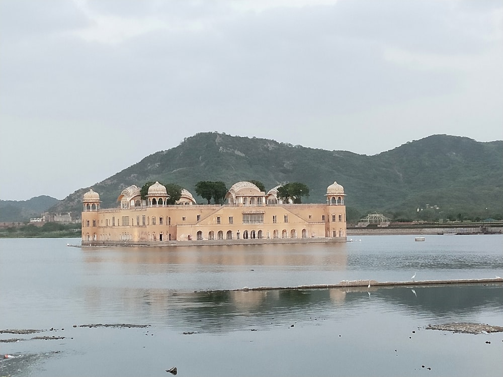 a large building sitting in the middle of a lake