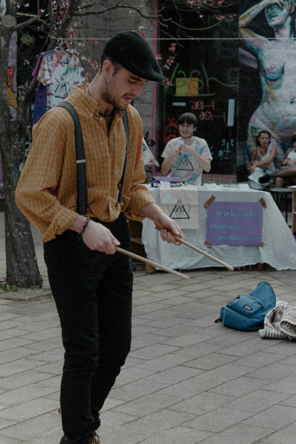 man holding brown drumsticks