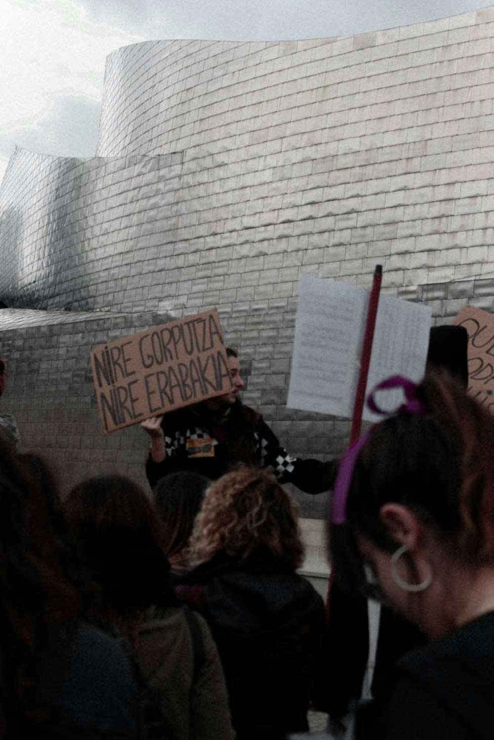 group of people protesting outside of building