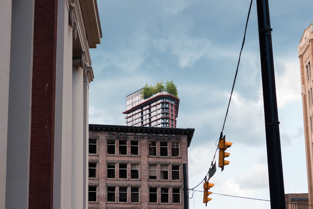 a traffic light hanging from a wire next to a tall building