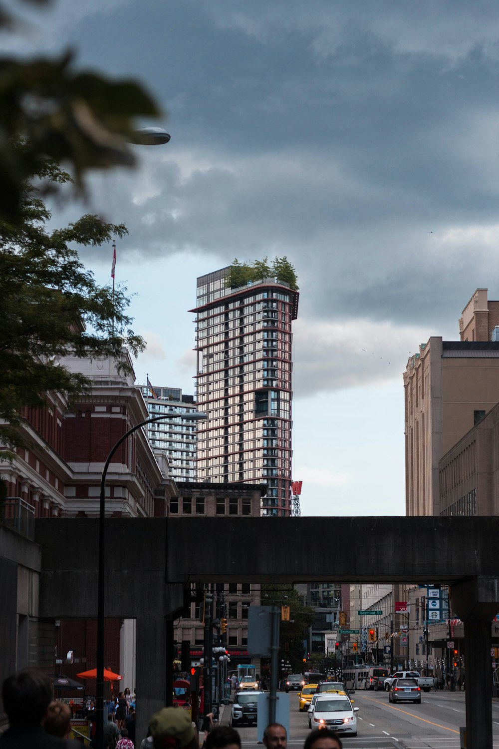 tall building near cars and bridge during daytime