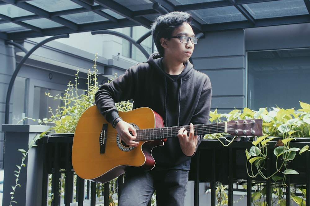 man playing an acoustic guitar