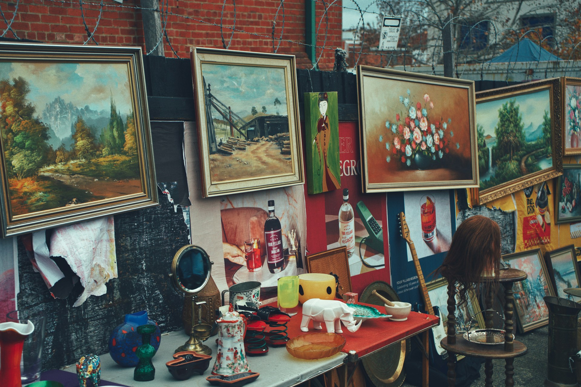 A beautifully arranged display of various art objects and antiques available for sale.