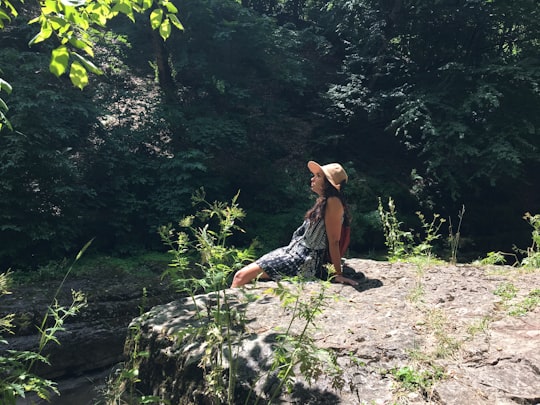 woman sitting on rock in forest in Tavush Province Armenia