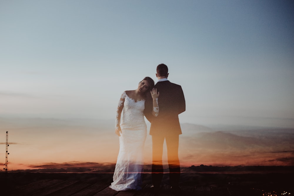 woman leaning her head to man's shoulder