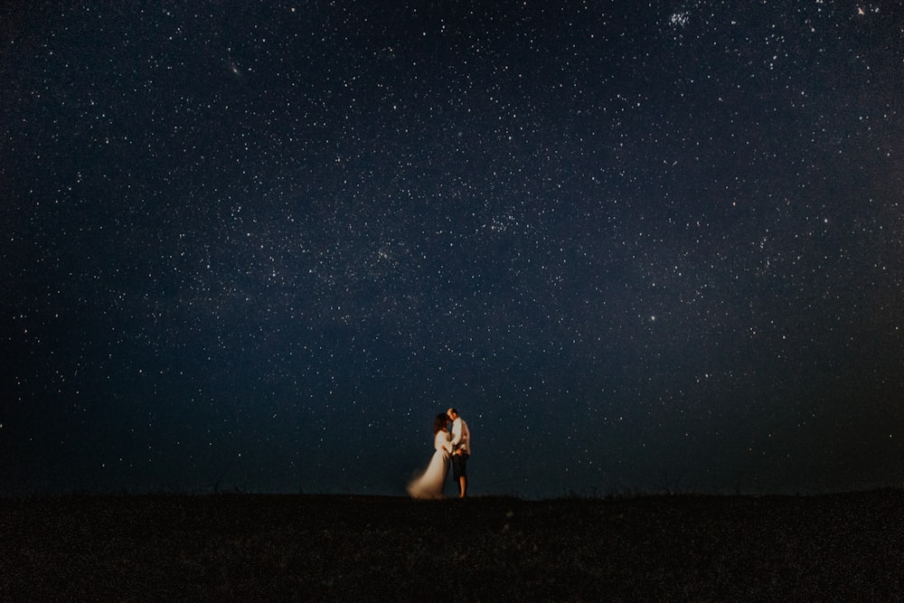 man and woman hugging at starry night