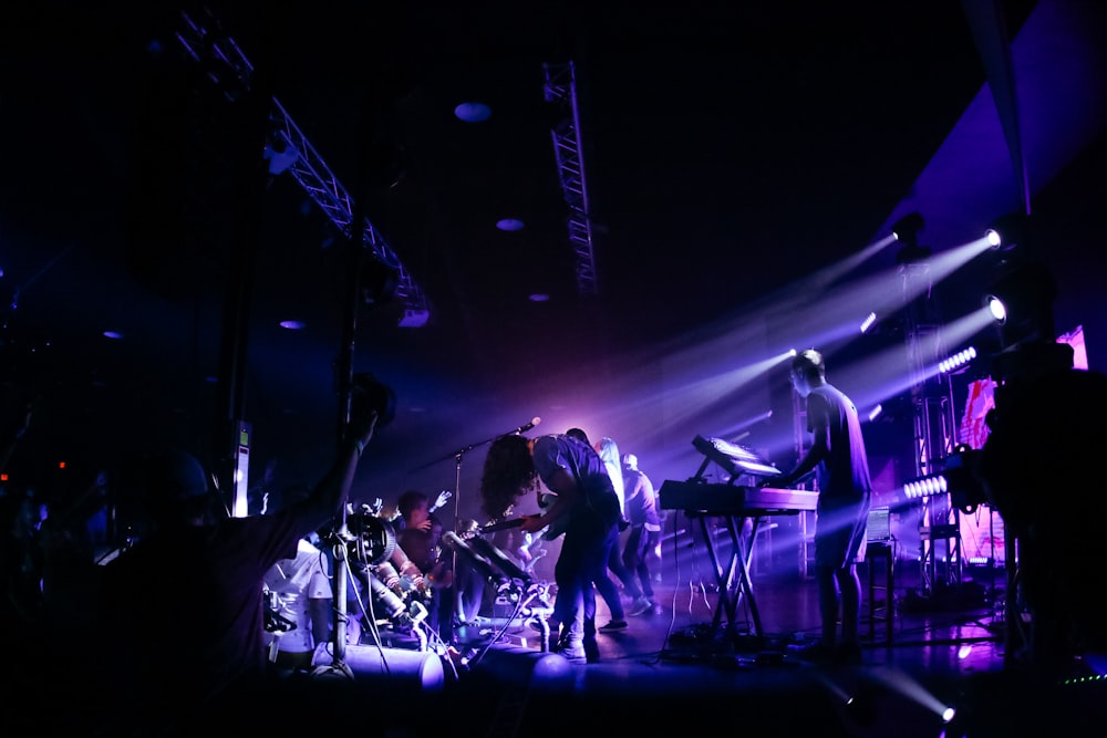 men playing instruments on stage